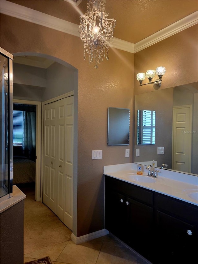 20188 Tesoro Dr, Venice, FL 34293 - bathroom with double vanity, a chandelier, crown molding, and tile patterned floors