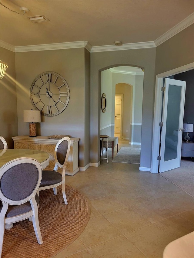 20188 Tesoro Dr, Venice, FL 34293 - dining area with arched walkways, ornamental molding, and light tile patterned flooring