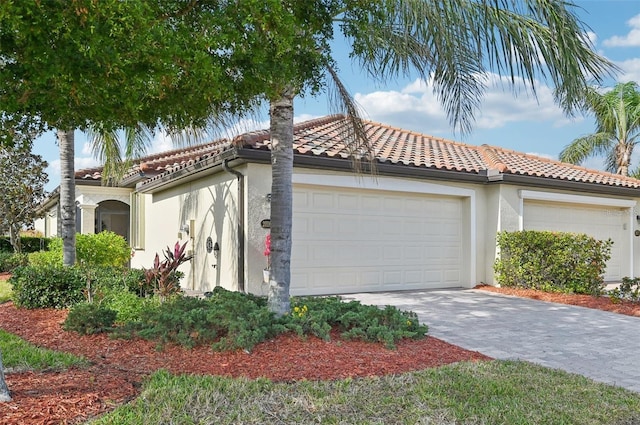 20188 Tesoro Dr, Venice, FL 34293 - mediterranean / spanish-style home featuring a garage, stucco siding, a tiled roof, and driveway