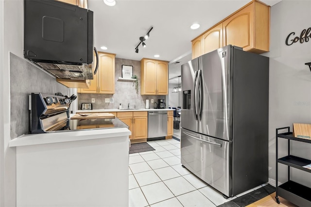 1629 Siesta Dr, Sarasota, FL 34239 - kitchen with recessed lighting, light tile patterned floors, light countertops, stainless steel appliances, and light brown cabinetry