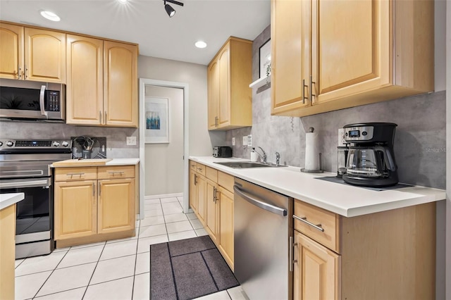 1629 Siesta Dr, Sarasota, FL 34239 - kitchen featuring appliances with stainless steel finishes, a sink, light brown cabinets, and light tile patterned floors