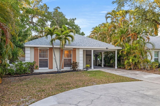 1629 Siesta Dr, Sarasota, FL 34239 - view of front of property featuring an attached carport, driveway, a shingled roof, and a front lawn