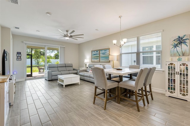 dining room with baseboards, light wood-style flooring, and a chandelier