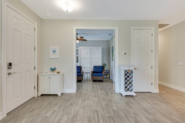 entryway with light wood-style flooring and baseboards