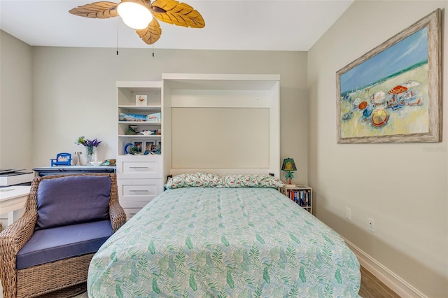 bedroom featuring wood finished floors, baseboards, and ceiling fan