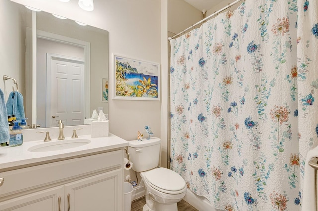 full bathroom with vanity, toilet, and curtained shower