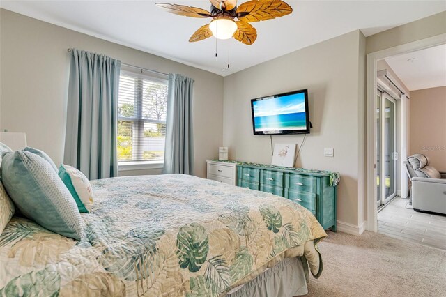 carpeted bedroom featuring baseboards and a ceiling fan