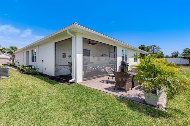 back of house featuring a patio area, a yard, central AC, ceiling fan, and stucco siding