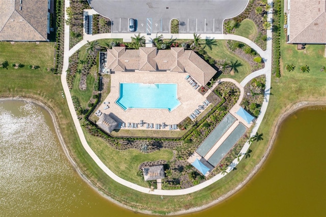 drone / aerial view of a pool and a large body of water