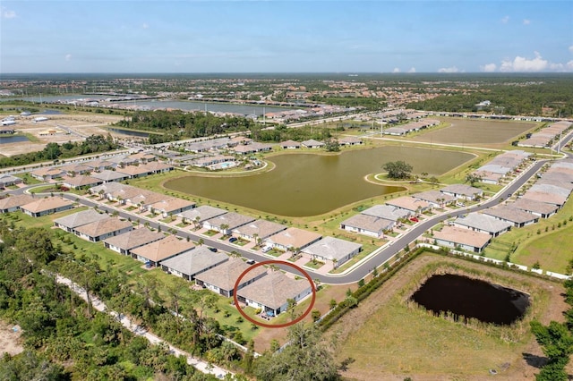aerial overview of property's location featuring a nearby body of water and nearby suburban area