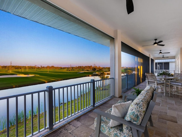 9810 Eagle Preserve Dr, Englewood, FL 34224 - balcony featuring a water view, view of golf course, a ceiling fan, and outdoor dining space