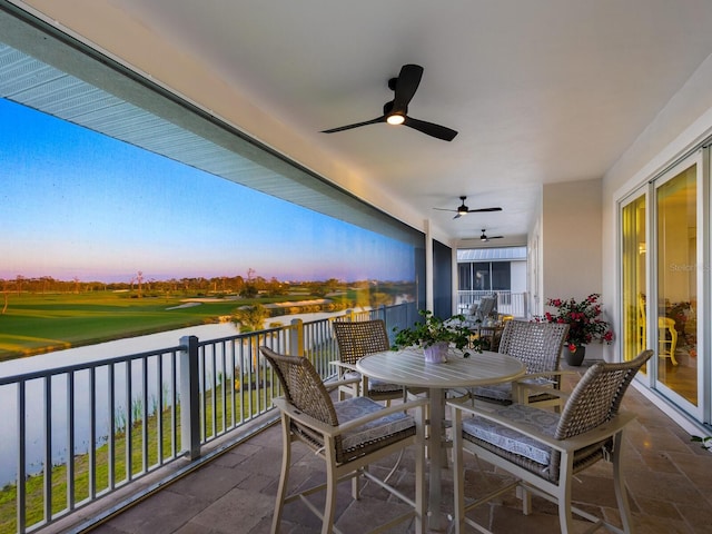 9810 Eagle Preserve Dr, Englewood, FL 34224 - balcony with a water view, outdoor dining area, ceiling fan, and golf course view