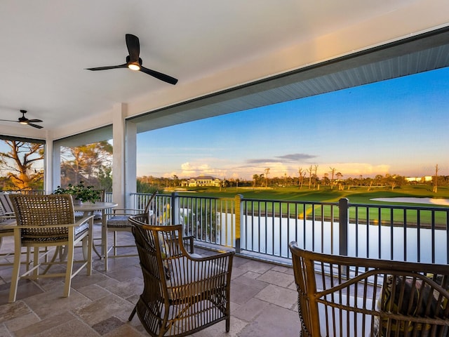9810 Eagle Preserve Dr, Englewood, FL 34224 - view of patio / terrace featuring a water view, view of golf course, ceiling fan, and outdoor dining space