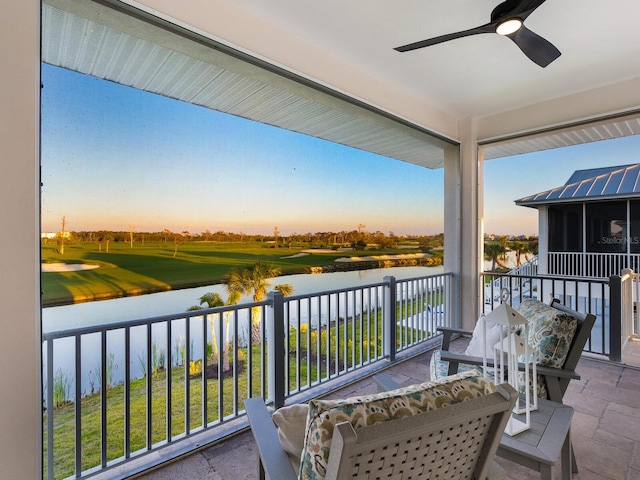 9810 Eagle Preserve Dr, Englewood, FL 34224 - balcony at dusk featuring a water view, ceiling fan, and view of golf course
