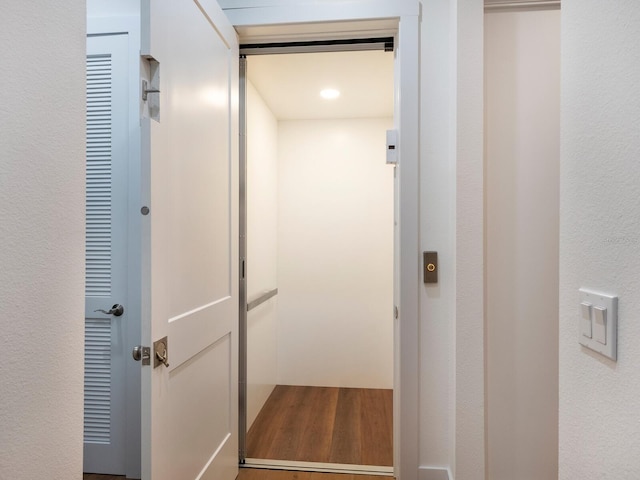 9810 Eagle Preserve Dr, Englewood, FL 34224 - interior space featuring elevator and wood finished floors