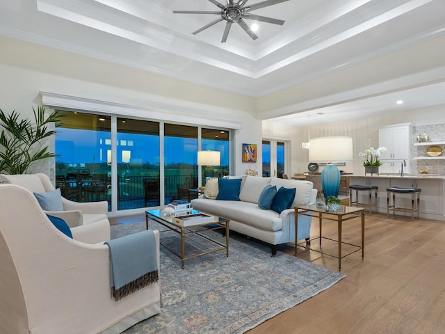 9810 Eagle Preserve Dr, Englewood, FL 34224 - living room with a ceiling fan, light wood-type flooring, a raised ceiling, ornamental molding, and recessed lighting