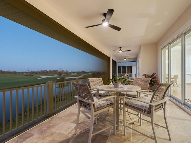 9810 Eagle Preserve Dr, Englewood, FL 34224 - balcony featuring a water view, view of golf course, a ceiling fan, outdoor dining area, and a patio