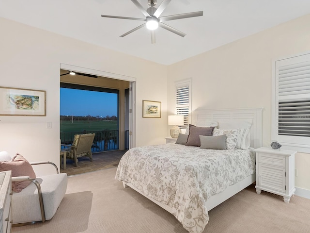 9810 Eagle Preserve Dr, Englewood, FL 34224 - bedroom with light carpet, a ceiling fan, and access to exterior