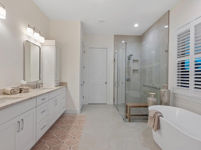 9810 Eagle Preserve Dr, Englewood, FL 34224 - bathroom with double vanity, recessed lighting, a freestanding bath, a sink, and a stall shower