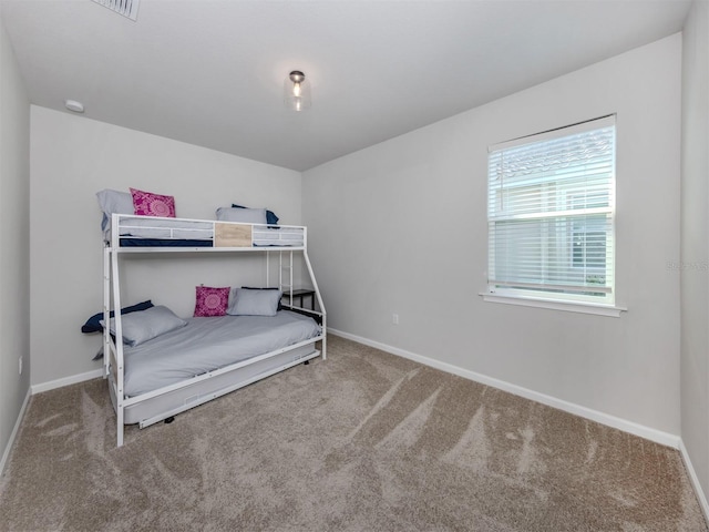 bedroom featuring baseboards and carpet