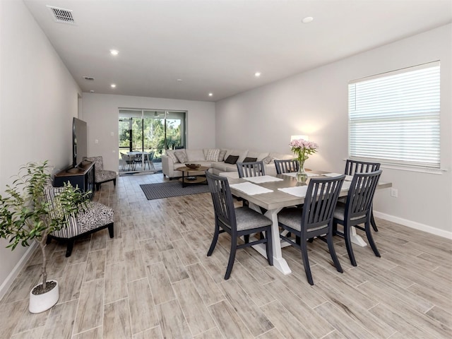 dining room with light wood-type flooring, baseboards, visible vents, and recessed lighting
