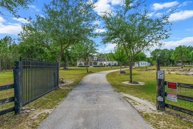 6824 283rd St E, Myakka City, FL 34251 - view of asphalt driveway featuring a gated entry