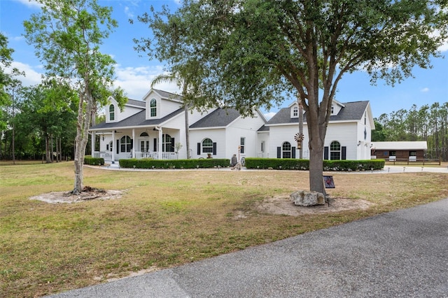 6824 283rd St E, Myakka City, FL 34251 - view of front facade with covered porch and a front lawn