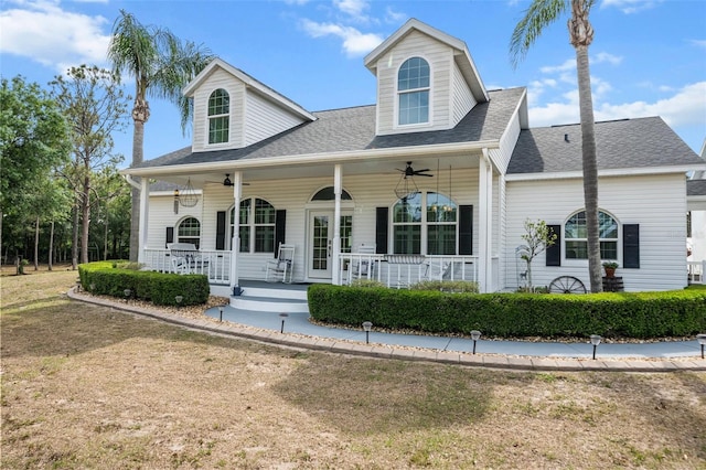 6824 283rd St E, Myakka City, FL 34251 - cape cod house with a porch, a ceiling fan, a front lawn, and a shingled roof