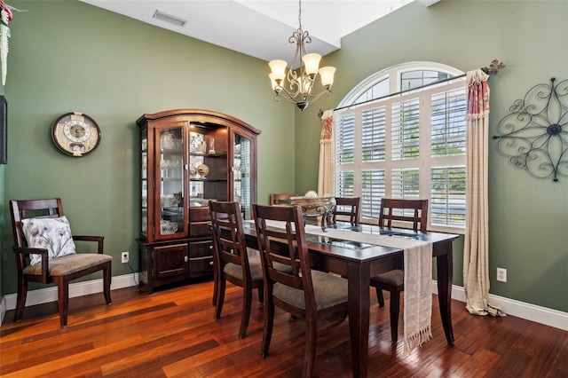 6824 283rd St E, Myakka City, FL 34251 - dining area with high vaulted ceiling, a chandelier, dark wood-style floors, and baseboards