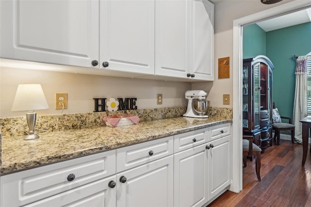 6824 283rd St E, Myakka City, FL 34251 - kitchen with white cabinetry, dark wood finished floors, and light stone counters