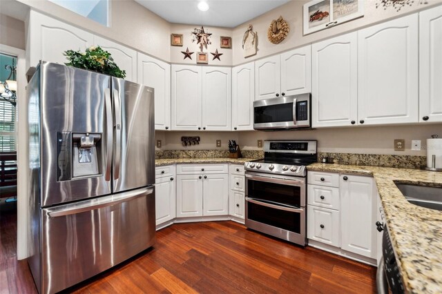 6824 283rd St E, Myakka City, FL 34251 - kitchen featuring stainless steel appliances, white cabinetry, dark wood-style floors, light stone counters, and recessed lighting