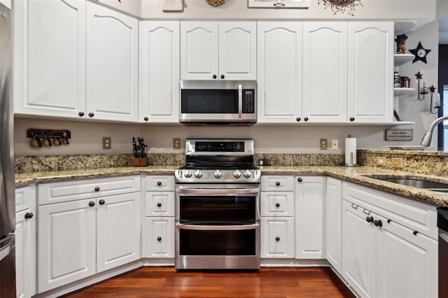 6824 283rd St E, Myakka City, FL 34251 - kitchen with appliances with stainless steel finishes, a sink, dark wood finished floors, and white cabinetry