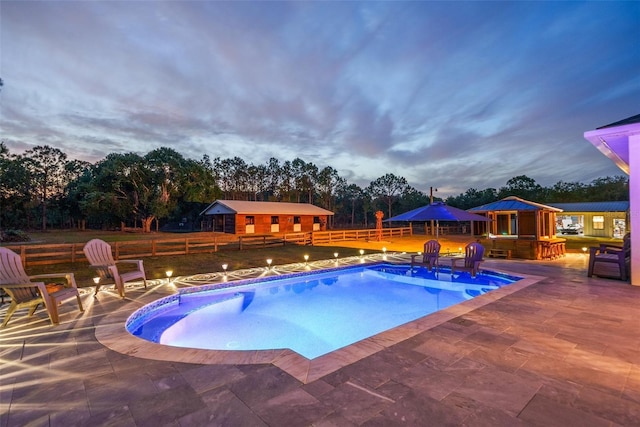 6824 283rd St E, Myakka City, FL 34251 - outdoor pool featuring fence, a patio, an outbuilding, a gazebo, and view of scattered trees