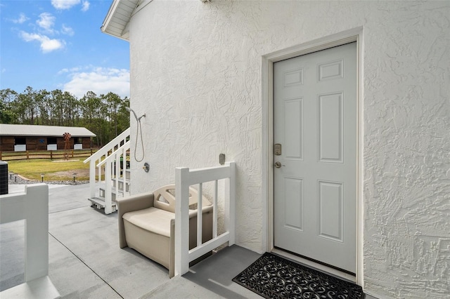 6824 283rd St E, Myakka City, FL 34251 - doorway to property featuring stucco siding and cooling unit