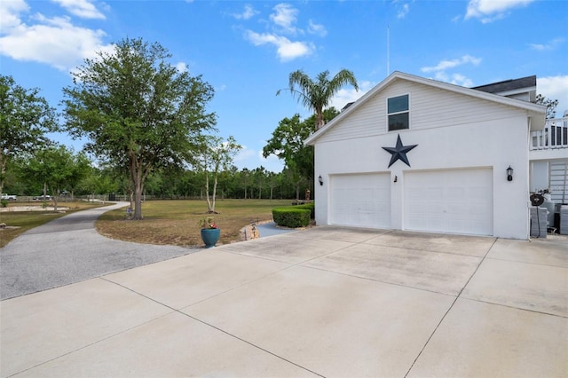 6824 283rd St E, Myakka City, FL 34251 - view of side of property featuring a garage, stucco siding, and concrete driveway