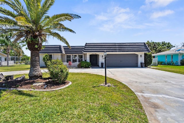205 Cavallini Dr, Nokomis, FL 34275 - view of front facade with an attached garage, driveway, fence, and a front yard