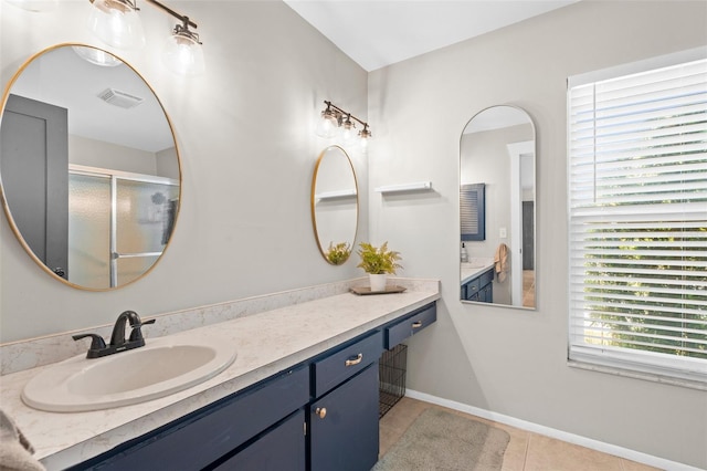 205 Cavallini Dr, Nokomis, FL 34275 - bathroom featuring tile patterned floors, visible vents, vanity, baseboards, and a stall shower