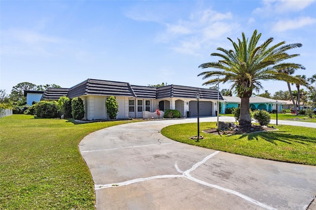 205 Cavallini Dr, Nokomis, FL 34275 - view of front of home with a garage, a front yard, and curved driveway