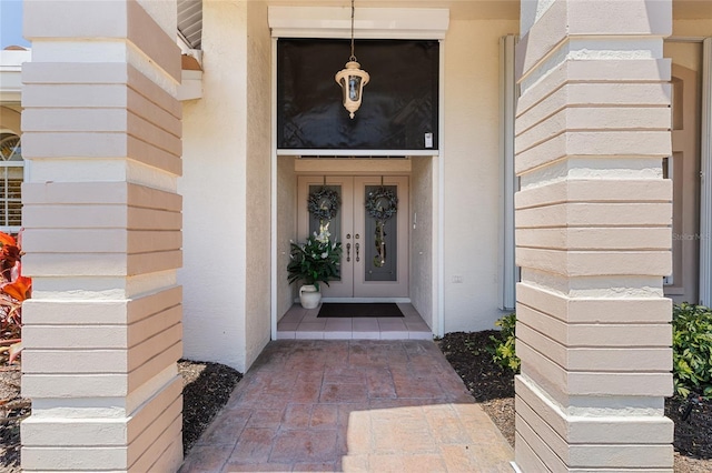 511 Governors Green Dr, Venice, FL 34293 - view of exterior entry with stucco siding and french doors