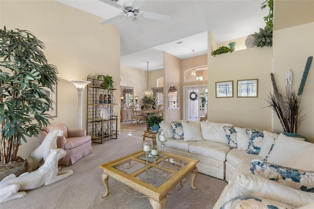 511 Governors Green Dr, Venice, FL 34293 - carpeted living room with ceiling fan with notable chandelier and high vaulted ceiling