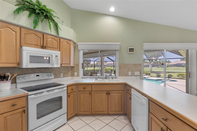 511 Governors Green Dr, Venice, FL 34293 - kitchen with vaulted ceiling, a sink, decorative backsplash, white appliances, and light countertops