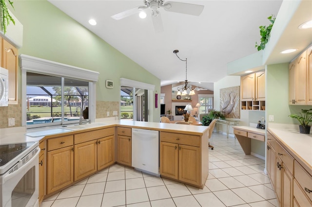 511 Governors Green Dr, Venice, FL 34293 - kitchen featuring a sink, decorative backsplash, white appliances, light countertops, and lofted ceiling