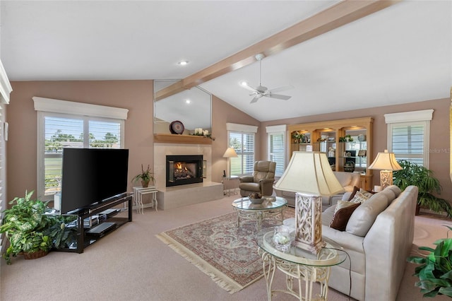 511 Governors Green Dr, Venice, FL 34293 - living area with a ceiling fan, lofted ceiling with beams, carpet floors, a healthy amount of sunlight, and a tile fireplace