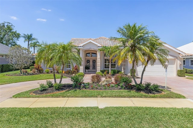 511 Governors Green Dr, Venice, FL 34293 - mediterranean / spanish home with a garage, french doors, a tile roof, and concrete driveway