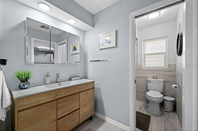 3355 Roslyn Rd, Venice, FL 34293 - bathroom with tile walls, visible vents, toilet, and vanity