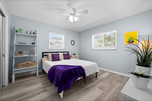 3355 Roslyn Rd, Venice, FL 34293 - bedroom with light wood-style floors, ceiling fan, baseboards, and multiple windows