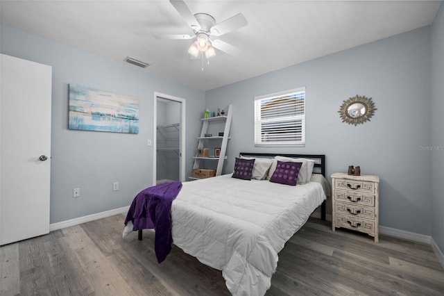 3355 Roslyn Rd, Venice, FL 34293 - bedroom with a spacious closet, wood finished floors, visible vents, a ceiling fan, and baseboards