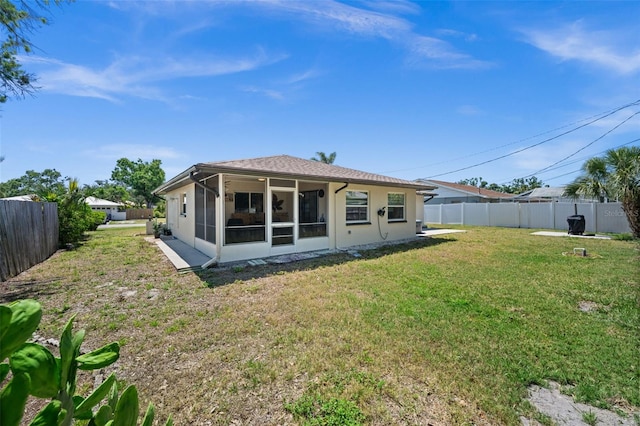 3355 Roslyn Rd, Venice, FL 34293 - back of house featuring a fenced backyard, a sunroom, a yard, and stucco siding