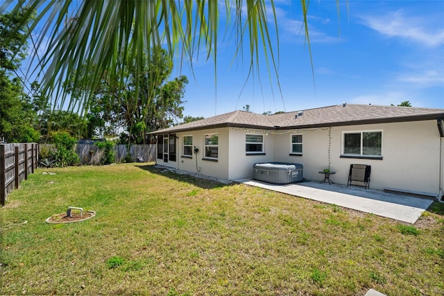3355 Roslyn Rd, Venice, FL 34293 - rear view of property with a fenced backyard, a lawn, a hot tub, a patio, and stucco siding