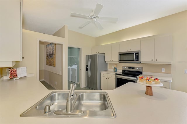 kitchen featuring a ceiling fan, a sink, stainless steel appliances, and light countertops